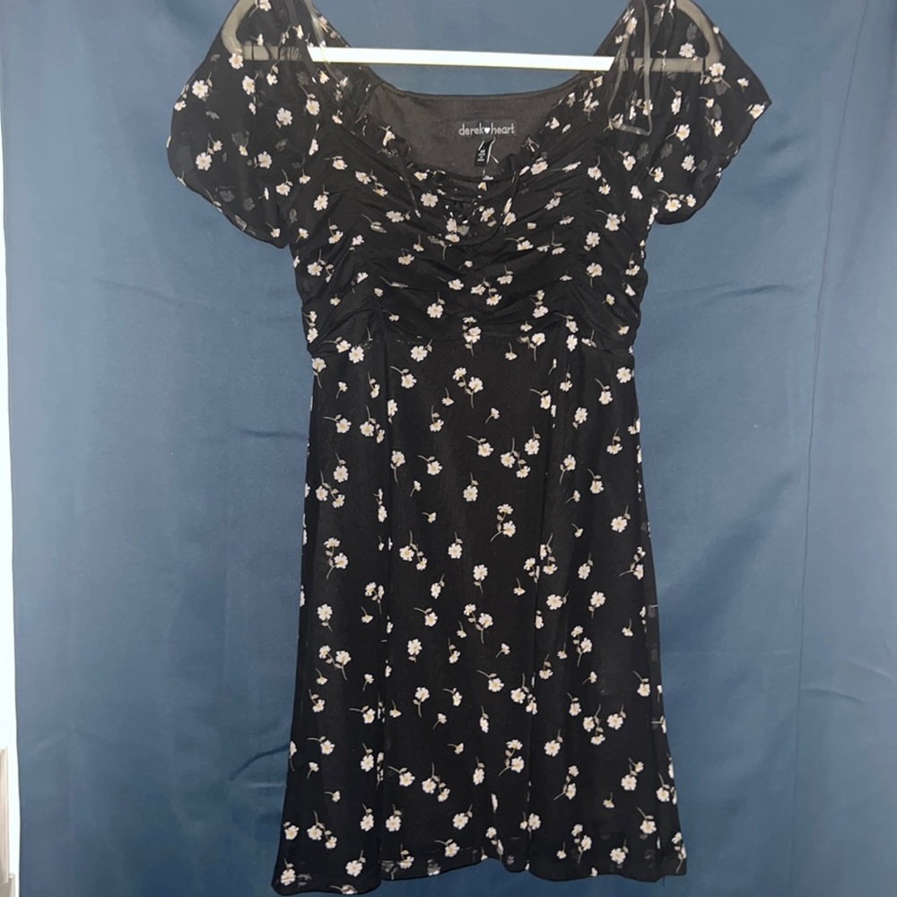 A black floral dress mesh off the should straps crossed in the front